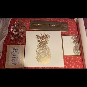 Rose gold pineapple paintings and chandelier.